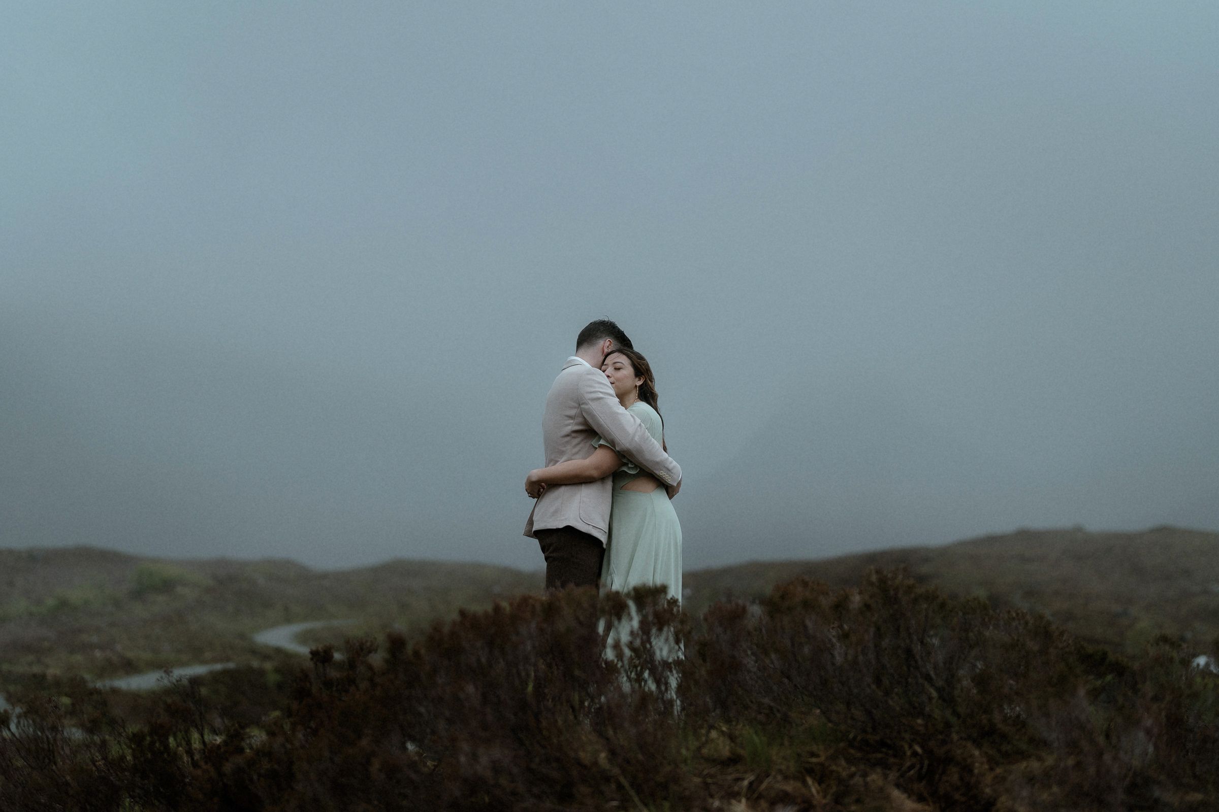 Bride and groom hold each other tight in the rain after their elopement on the Isle of Skye, Scotland