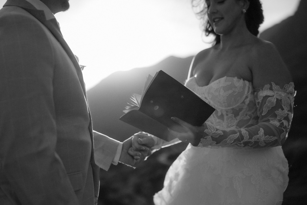 A bride and groom read their vows during their Scottish elopement in the mountains