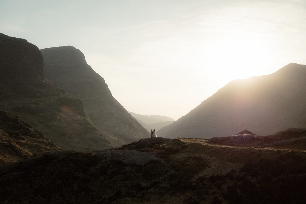 Couple stand together in the mountains during their elopement in Scotland