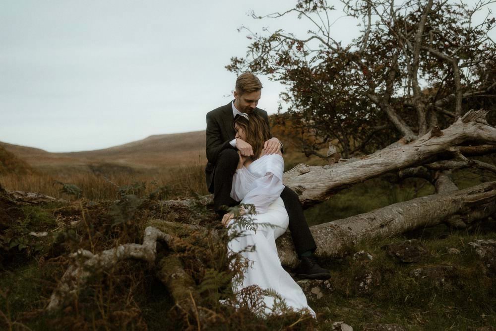 A couple hold each other in the Scottish Highlands at the end of their wedding day on the Isle of Skye