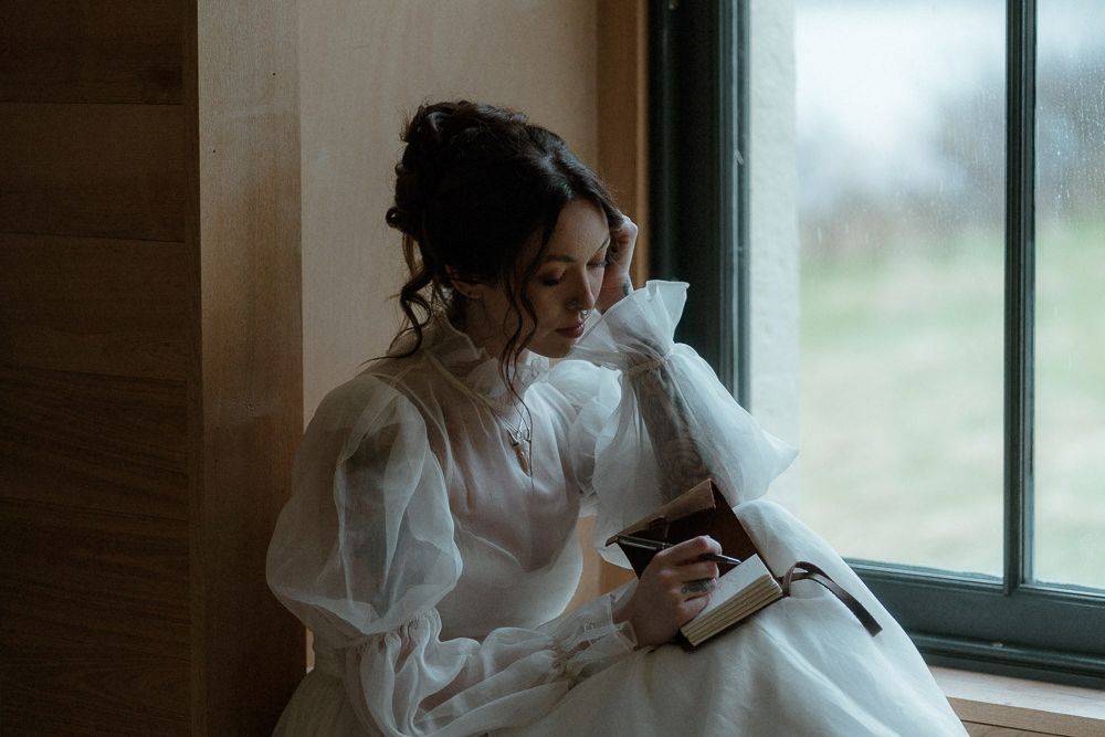 A bride writes her vows in a secluded cottage before her elopement ceremony on the Isle of Skye, Scotland