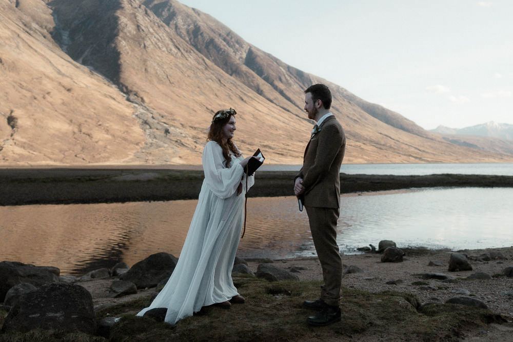 Couple read their vows on the banks of Glen Etive during their late afternoon elopement in Scotland