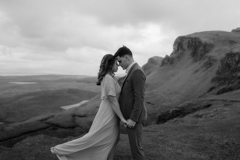 Couple hold hands on a mountain after their elopement on the Isle of Skye, Scotland