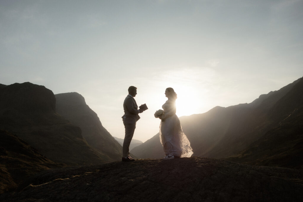 A couple read their vows on a Scottish mountaintop during their wedding ceremony at sunset