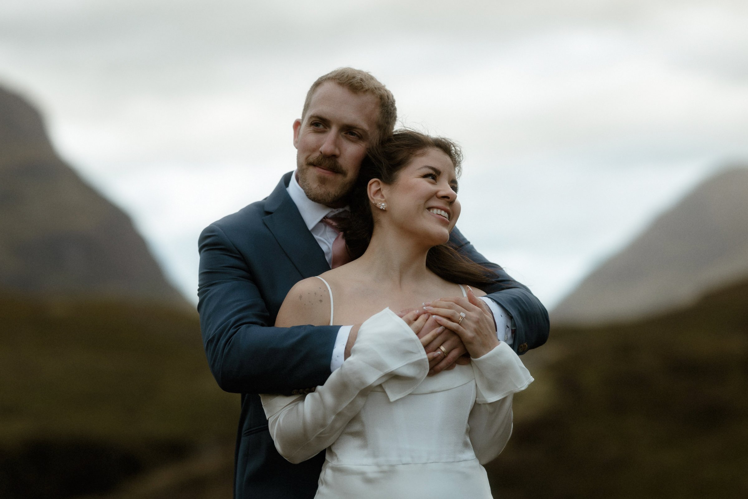 A couple embracing amongst the mountains of Glencoe during the Scottish elopement
