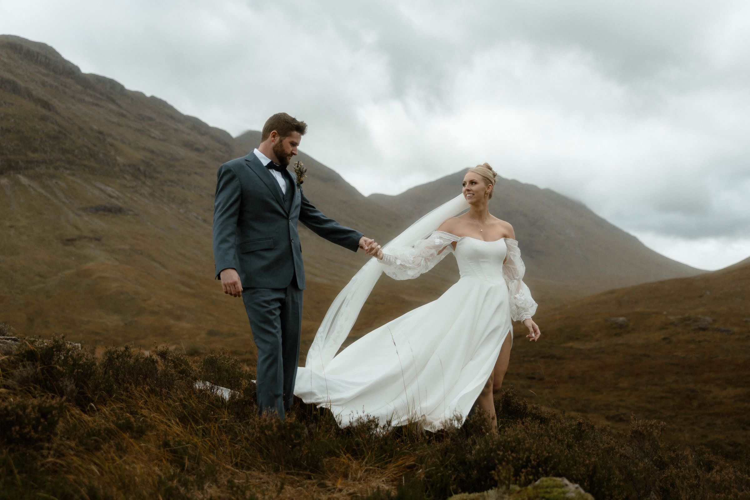 A bride and groom roam the hills of Glencoe on their wedding day